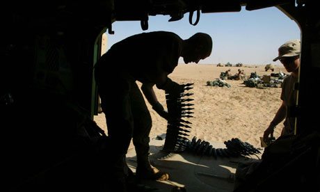 Spc Travis Hunter loads armor-piercing depleted uranium-tipped shells during the second Iraq war