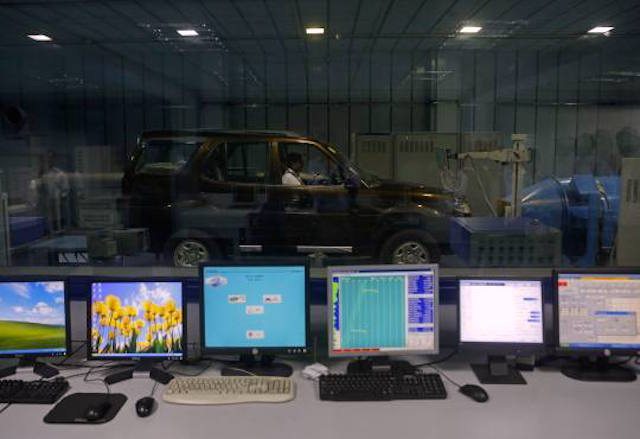 An engineer tests Tata Safari car inside emission testing facility at Tata Motors plant in Pimpri
